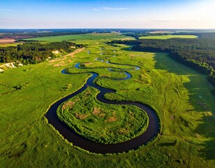 Winding river flows through grassy landscape