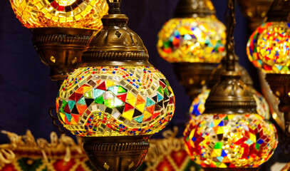 Turkish mosaic lamps illuminating a bazaar stall, showing traditional decorative art from the middle east