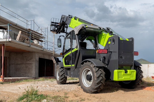 Forklift on a construction site, preparing to raise construction parts