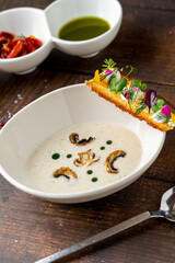 Creamy mushroom soup garnished with sautéed mushrooms and crisp
