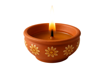 Terracotta clay diya oil lamp featuring painted white and yellow flower design glowing brightly for the happy diwali festival isolated on transparent background