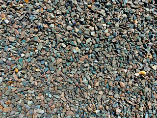 A pile of rocks with a blue tint. The rocks are scattered and the pile is not uniform