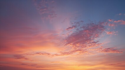 Naklejka premium Stunning sunset sky with vibrant colors and soft clouds offers a sense of peace and wonder for travel, mindfulness, or inspirational projects