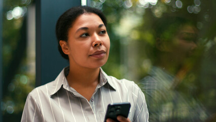 Happy, Hispanic Business Woman Work Using Smartphone Phone. Motivation, Success at Office. Excited, Employee, Lawyer, Female Businesswoman Corporate Job. Greenhouse background