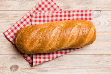 freshly baked bread with napkin on rustic table top view. Healthy white bread loaf isolated