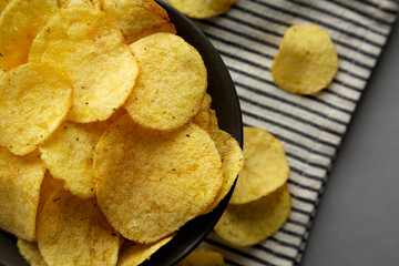 Sour Cream and Onion Flavored Chips in a Bowl, top view. Flat lay, overhead.