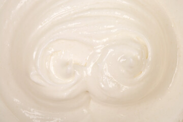 A full-frame, close-up view shows a thick, white, creamy whipped egg white and sugar texture with swirls