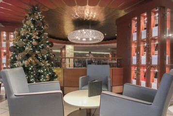Elegant interior design furnishing bar lounge area onboard cruiseship cruise ship liner in Art Deco design with chairs, tables, bar counter and room dividers