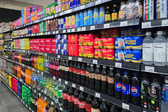 Penang, Malaysia &ndash; Sep 26, 2025: A wide-angle view of a colorful display of soft drinks and energy beverages inside Mercato grocery store.