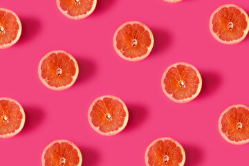 Grapefruit pattern on pink backround.Minimal flat lay concept