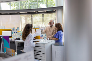 Pharmacist guiding customers over prescription at pharmacy