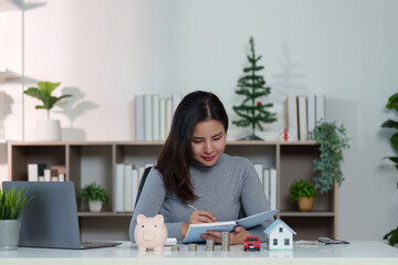 Financial Planning. Woman writing in notebook, managing savings and investments.