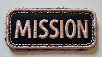 Patch with word MISSION sewn onto fabric representing military objective