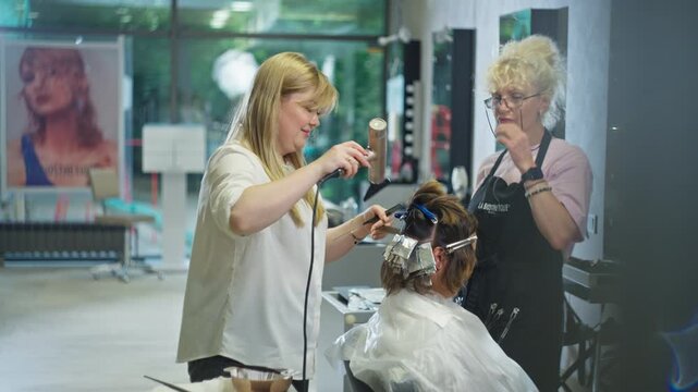 Professional stylist applies highlighting to female hair in beauty salon with hairstyle care services hair coloring beauty treatment and modern appearance makeover