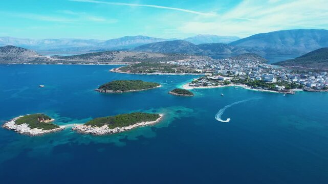 Ksamil Islands with Boats Sailing on Blue Turquoise Sea, Tourists Sunbathe on White Beach