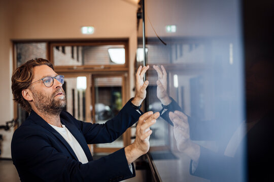 Businessman using big touch screen in modern office meeting room