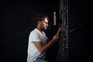 Engineer working on server electronics in modern office environment