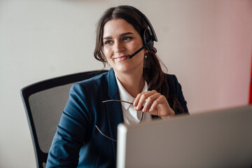 Smiling customer service consultant with headset in office environment