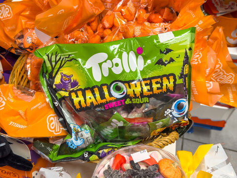 Trieste, Italy - October 14, 2025: Colorful Trolli Halloween sweet and sour candy bag displayed among festive treats in a vibrant store setting, perfect for seasonal celebrations