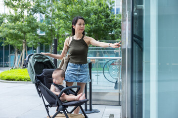 Mother push baby stroller inside lift elevator © leungchopan