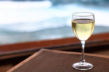a glass of white wine on the background of the sea relaxing by the sea with wine