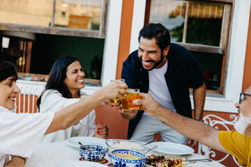 Family gathering outdoors to celebrate with food and beverages