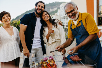 Family enjoying a Brazilian churrasco barbecue on a sunny day outdoors