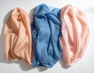 Three draped pastel cloths, soft fabric, clean white back