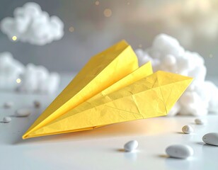 Yellow paper plane rests against fluffy white clouds