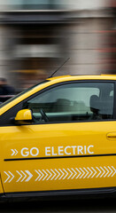 Yellow electric car with &ldquo;GO ELECTRIC&rdquo; text in city background.