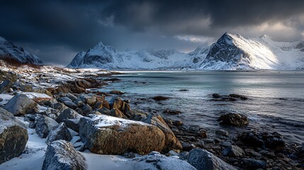 snow capped mountains meet a dramatic rocky norwegian winter seascape
