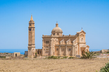 Imposing Romanesque Basilica of the National Shrine of the Blessed Virgin of Ta' Pinu with bell...