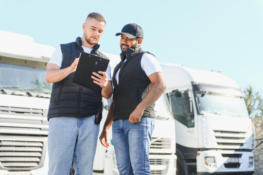 Truck drivers discussing logistics and shipping documents