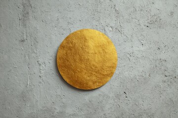 Gold circle on textured wall