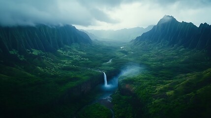 Lush green valley with a waterfall cascading down the mountainside, surrounded by dense vegetation and shrouded in mist, creating a serene landscape