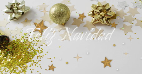 Feliz Navidad text image over Christmas decorations with stars and glitter