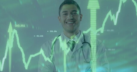 Smiling male doctor wearing lab coat stethoscope in studio showing green financial chart and arrows