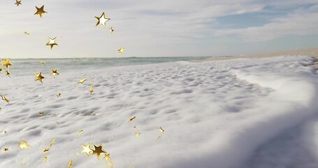 Covering frothy sea foam rolling across sandy beach, with golden star ornaments and ocean waves