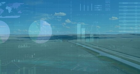 Displaying straight paved canal bisecting rural plain under blue sky, with digital chart overlays