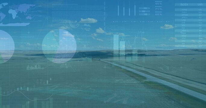 Displaying straight paved canal bisecting rural plain under blue sky, with digital chart overlays