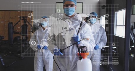 Spraying technicians disinfecting gym machines in gym, with sprayer and world map overlay