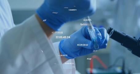 Presenting gloved hand in lab coat holding test tube near microscope in lab, with digital overlays