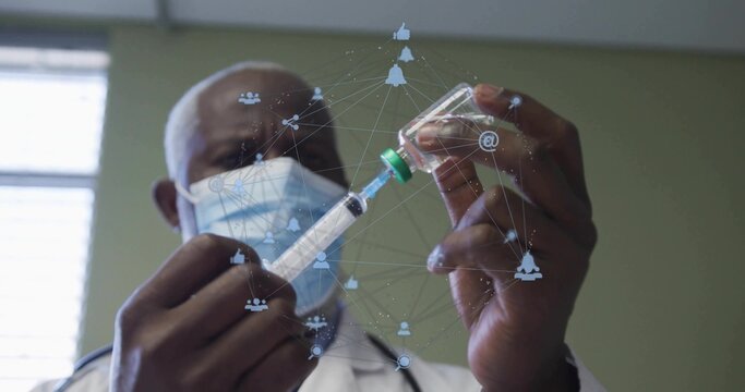 Drawing medicine from vial into syringe in clinic, doctor wearing mask and coat with digital icons - Powered by Adobe