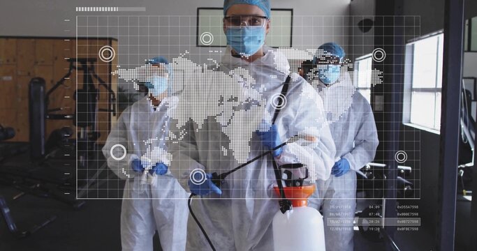 Spraying technicians disinfecting gym machines in gym, with sprayer and world map overlay - Powered by Adobe