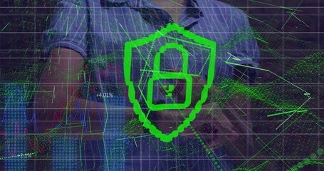 Typing IT professional in blue shirt analyzing security data on laptop at desk, with shield icon
