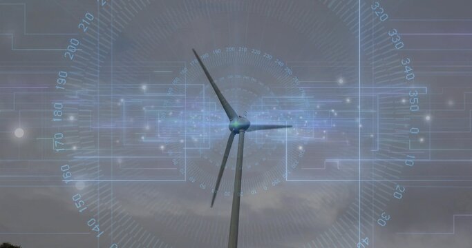 Displaying wind turbine rotating blades under cloudy sky on wind farm, with digital HUD overlay
