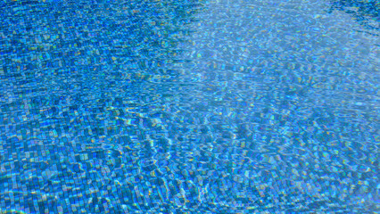 Swimming pool water surface and ripple wave with blue mosaic tiles