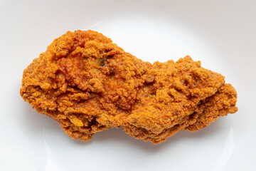 crispy fried chicken on white plate close up