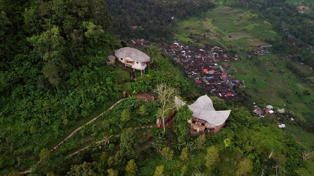 Stunning aerial drone footage of a tropical bamboo villa on a lush hill in Sidemen, Bali. Surrounded by jungle and rice terraces, this eco retreat combines natural beauty with authentic island charm.