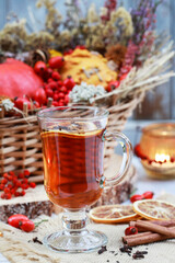 Hot tea on the table, against the background of beautiful autumn decorations.